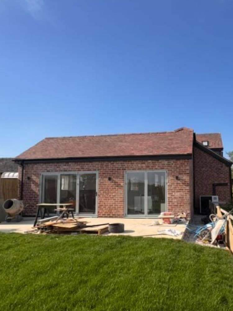 Side view of slate roofing on barn conversion in Loscoe