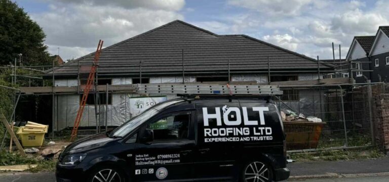 Holt Roofing Ltd company van parked beside a finished roof