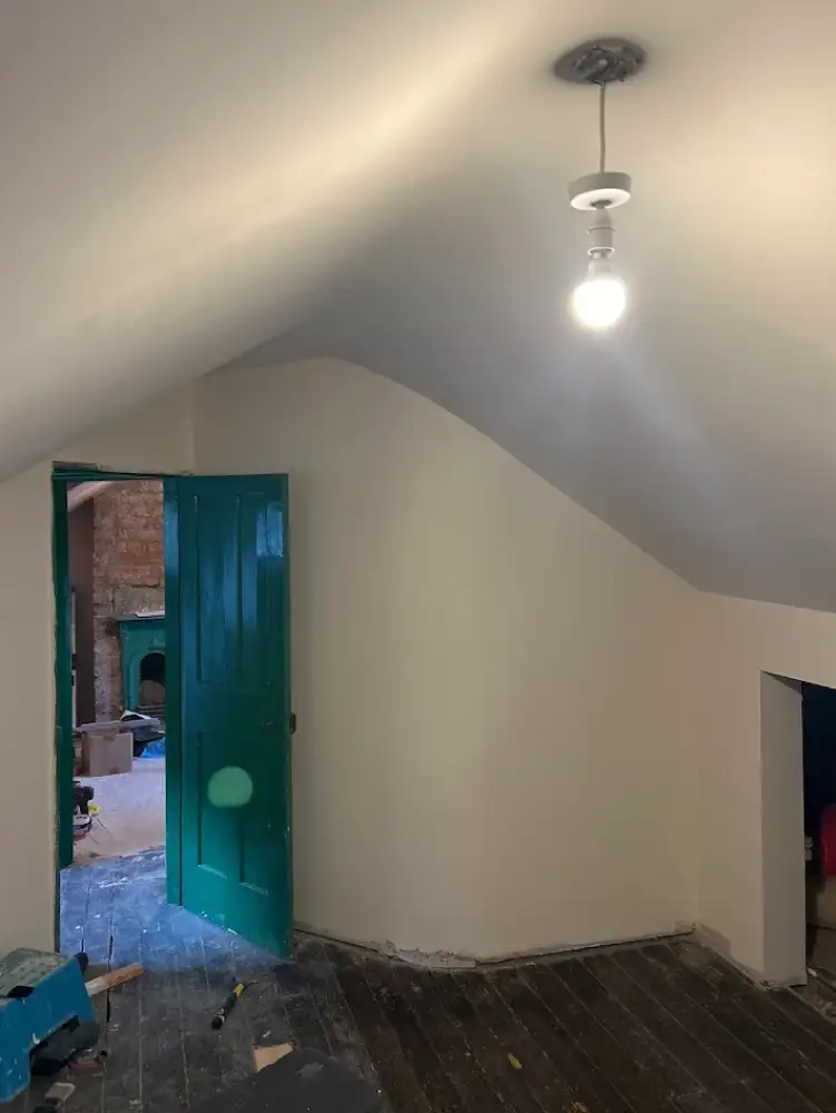 Back room of Ambergate loft conversion with finished walls and ceiling lighting
