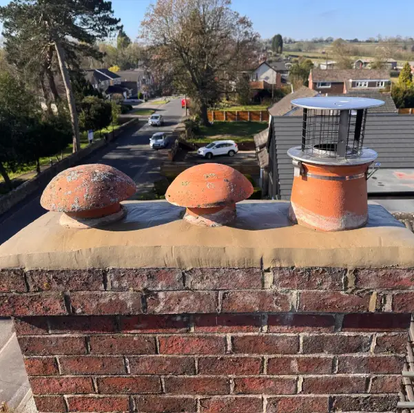 Chimney stack in Derbyshire showing new flaunching repair and chimney pots