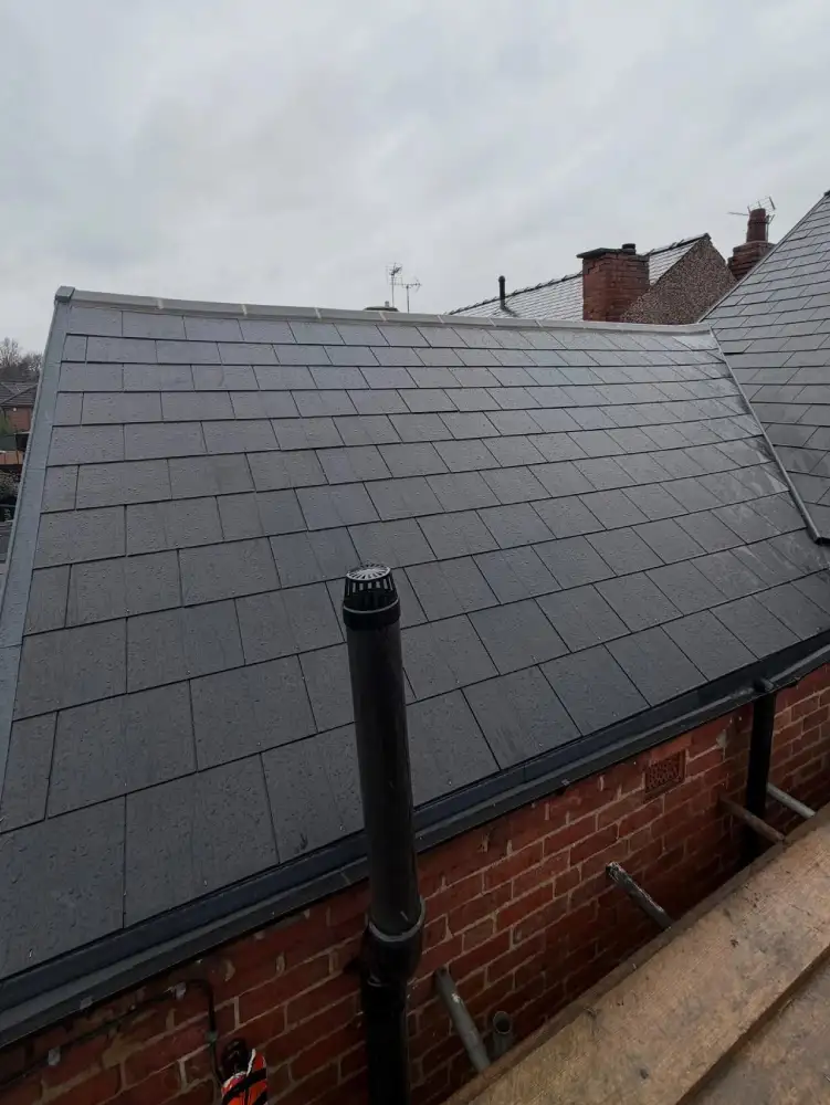 Cement fibre slate reroof viewed from side angle during completion